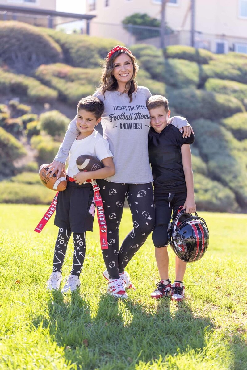 mom with her two sons in football gear