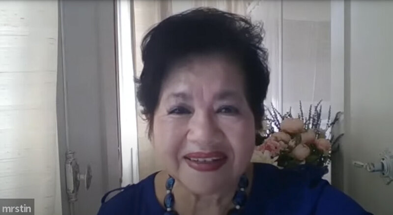 Nita Tin wearing a blue dress, smiling into the camera as a guest on the Women’s World Leaders Podcast, Empowering Lives with Purpose, hosted by Kimberly Hobbs.