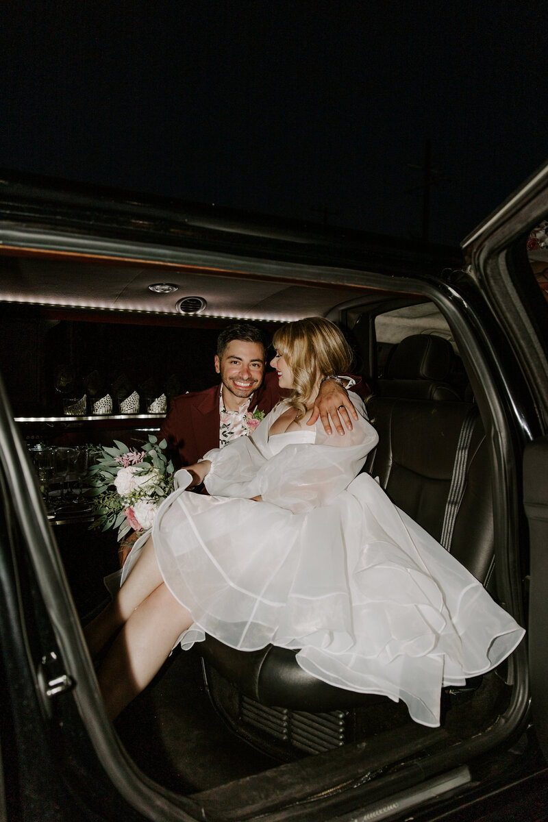 A couple poses in a limo