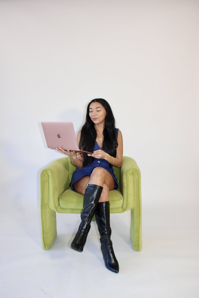 Bri working on her laptop, creating strategic social media content for small businesses.