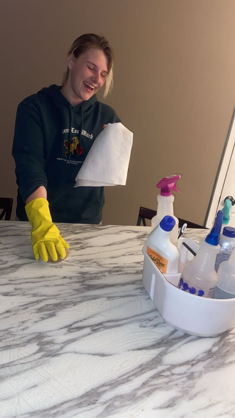 Co-founder scrubbing a countertop during a residential deep clean
