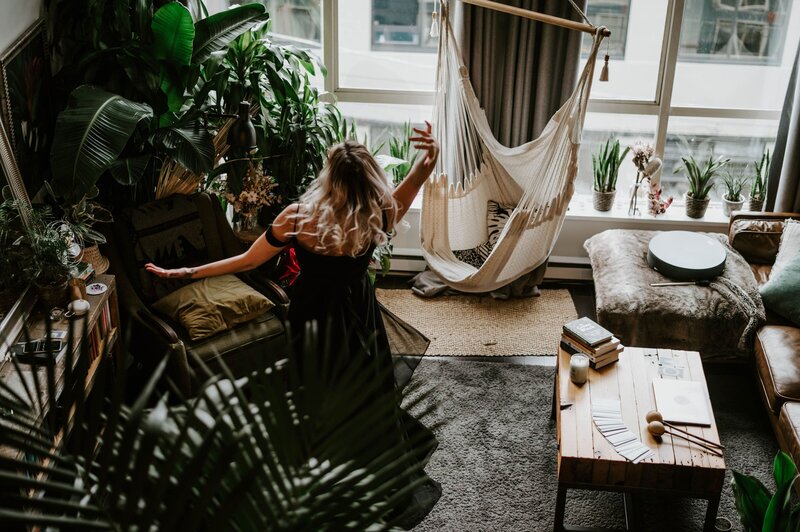 Shae is dancing in a living room with lots of plants