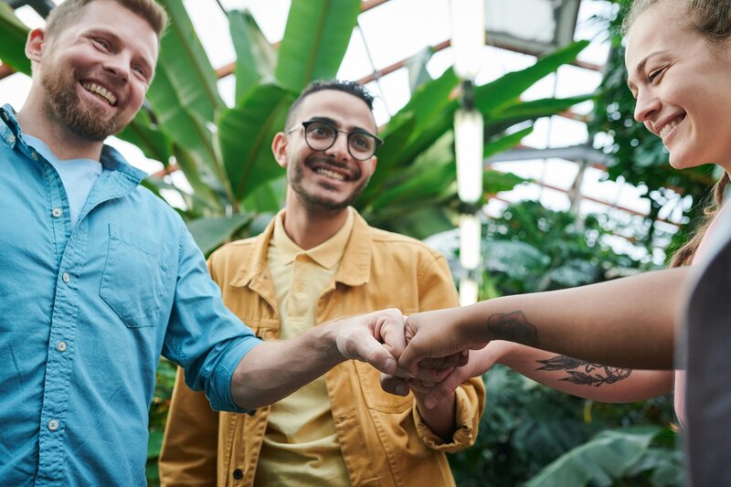Image of a group of patients supporting each other with a fist bump