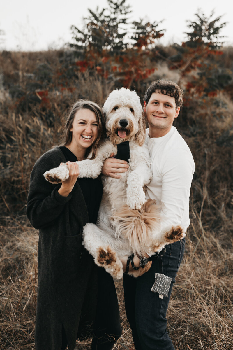 Couple with goldendoodle dog