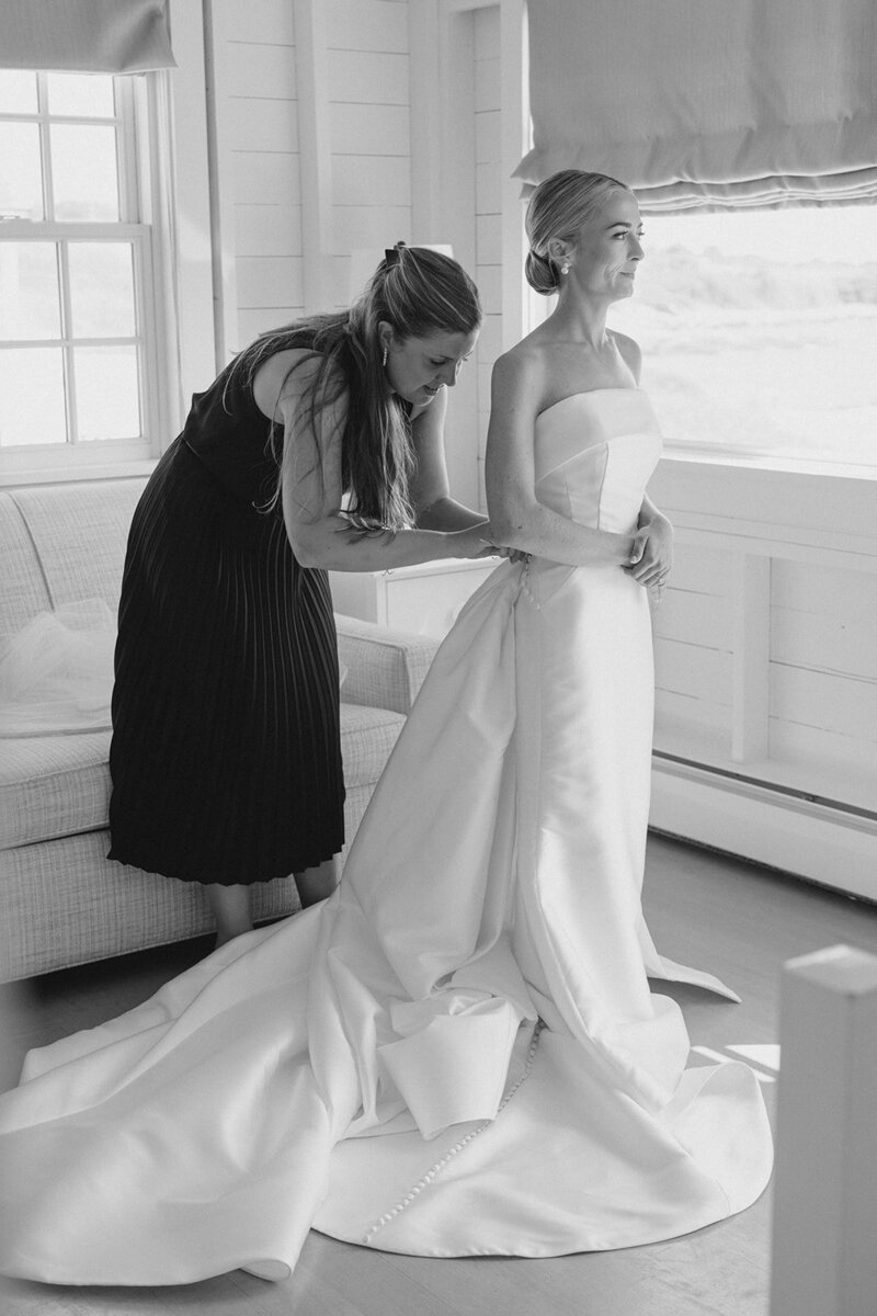 Stylist walking holding bride's train