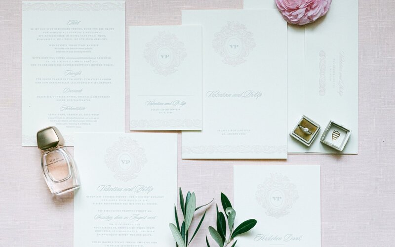 Bespoke wedding stationery detailed flatlay with parfume and wedding ring 