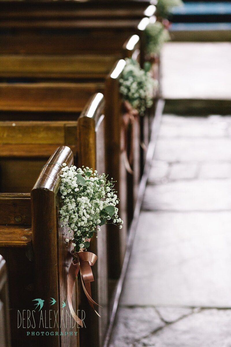Church pew ends of gypsophila and eucalyptus.