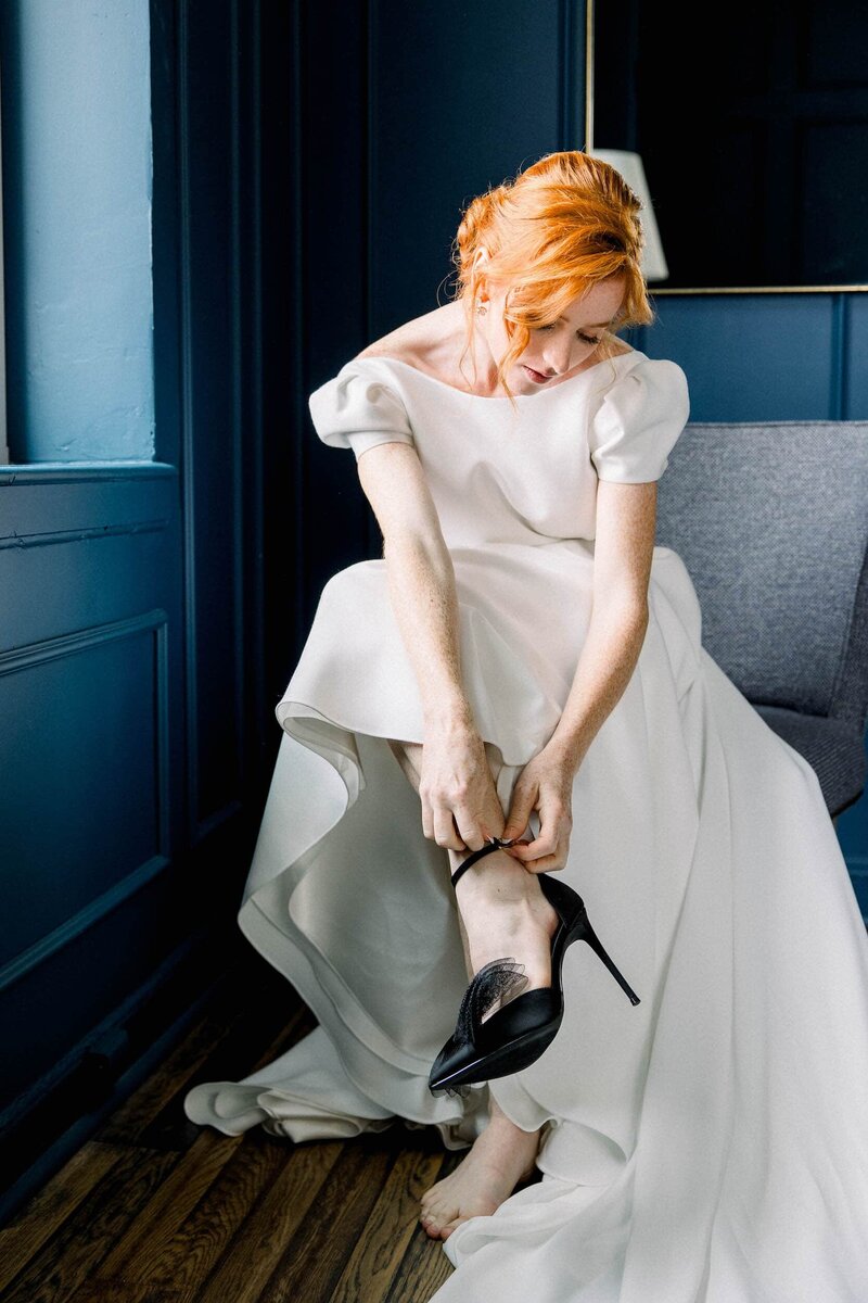 Bride putting on shoes