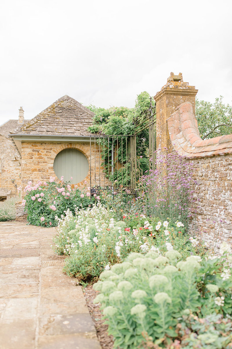 Flower beds in a walled garden, next to a gate