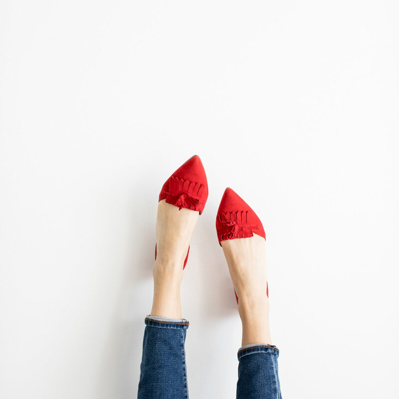 Red shoes against white background