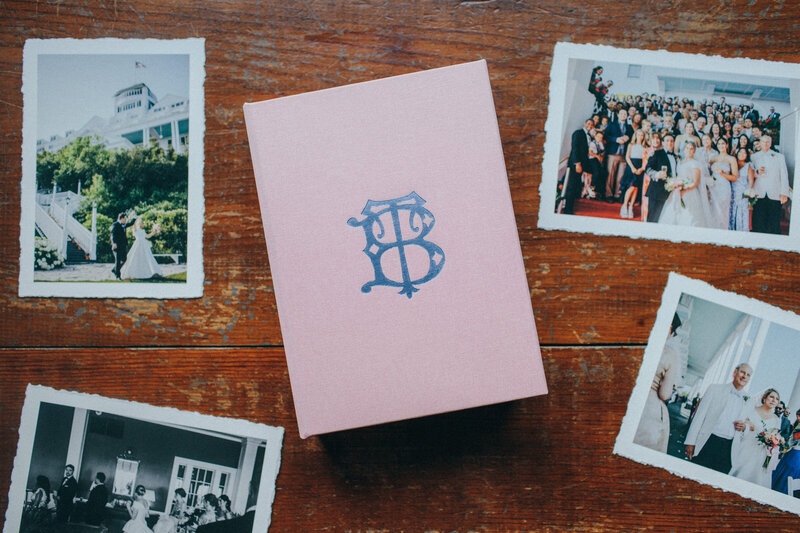 a pink print box with deckled prints scattered around it