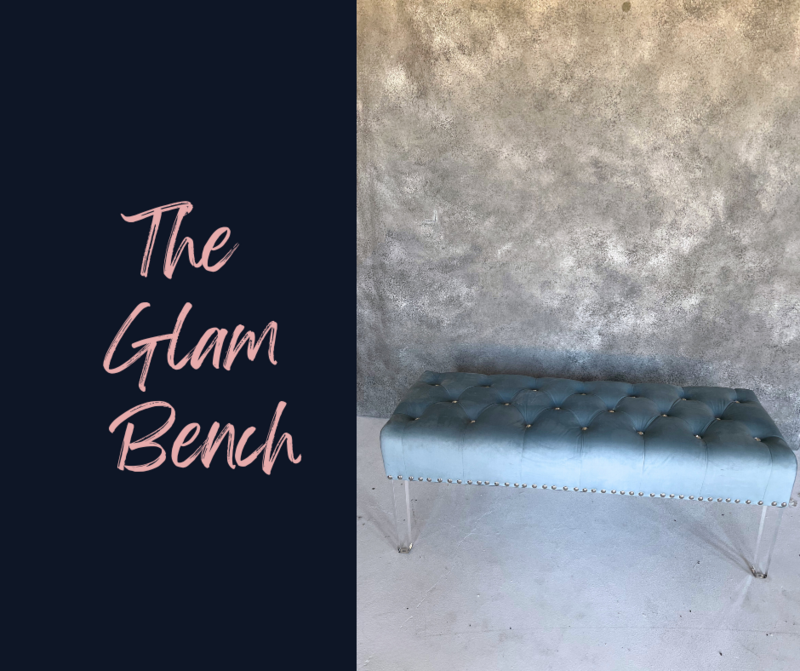 blue tufted bench against a grey background for a boudoir session in Minneapolis Mn