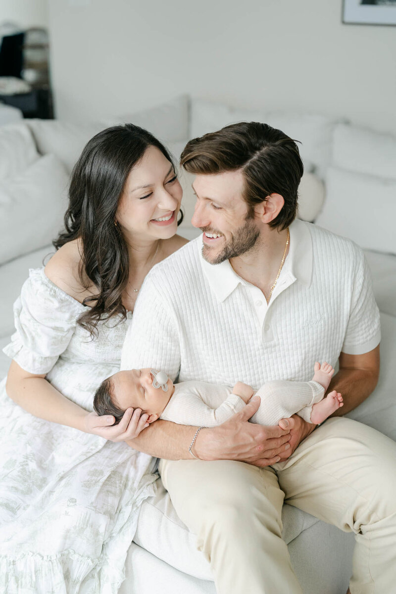 Mother and father hold sleeping baby boy during her philly newborn session