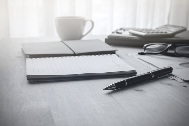 cup-of-coffee-on-wooden-desk-and-stack-of-document-2023-11-27-05-20-18-utc