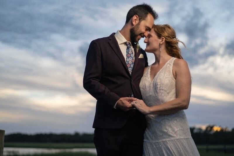 Newlyweds embracing at sunset