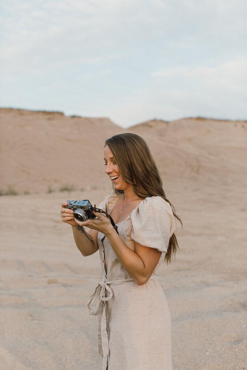 woman  holding camera and laughing