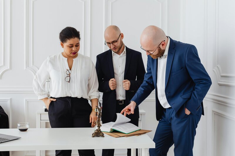 People reviewing paperwork at desk