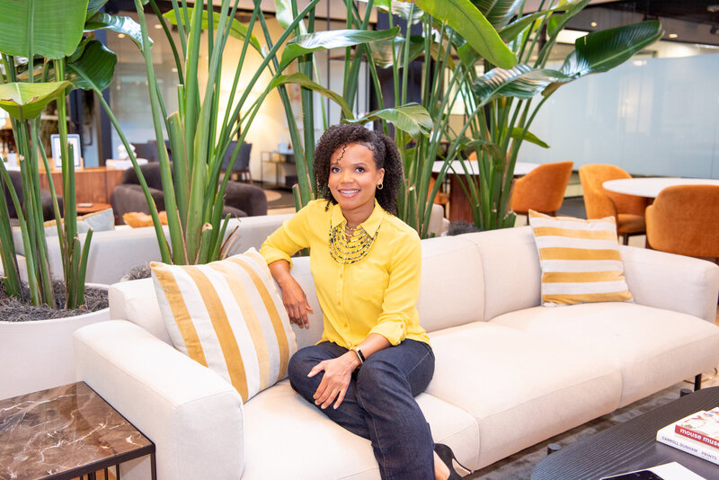 A small business attorney sitting on a couch at Industrious in Short Hills, New Jersey.