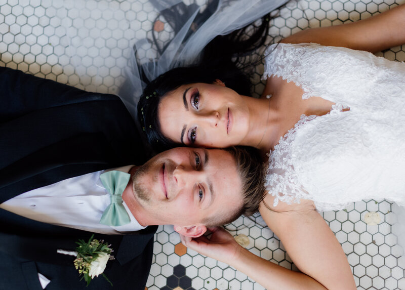 couple lying down together and looking up at photographer Oregon Coast Elopement and Wedding Photographer