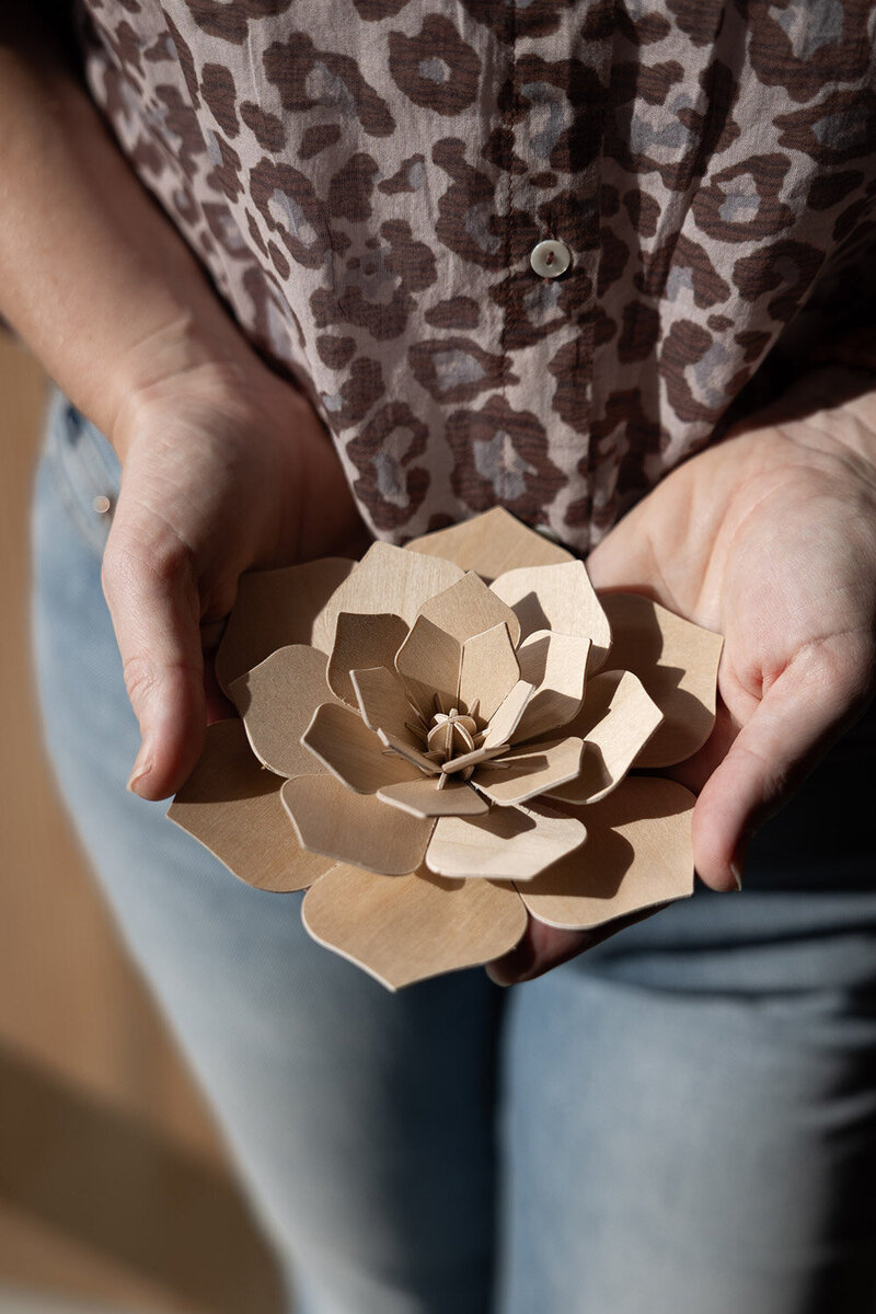 Houten lelie als symbool van veerkracht & groei vastgehouden door Agnes Tuin