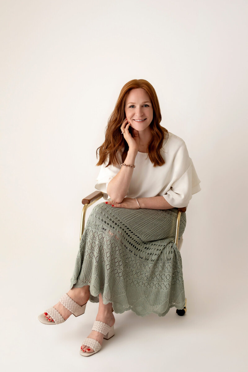 photographer in los angeles sitting on chair and smiling at the camera