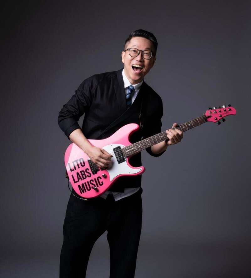 Dan laughing with a pink LITO Labs Music guitar