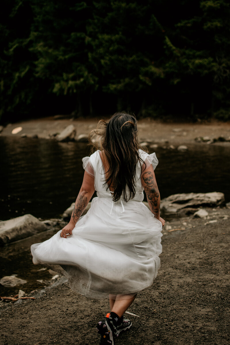 Bride running on the edge of Trillium Lake in Mt Hood National Forest.