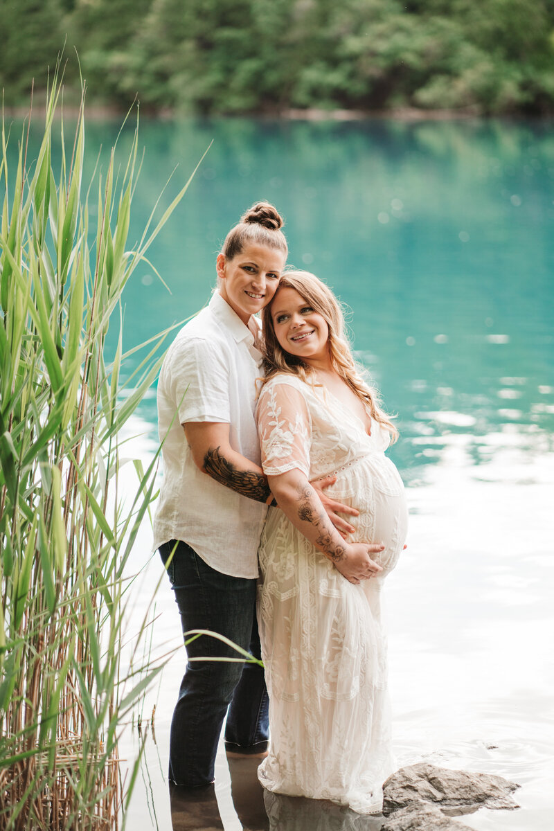 mothers holding baby belly and looking on in syracuse new york