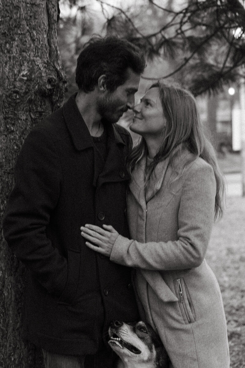 A candid, sunlit moment of a couple holding hands and laughing during a golden hour session in Montreal.