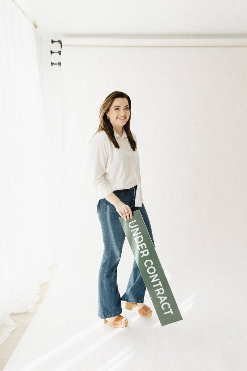 Computer and work related items scattered on the ground next to woman's leg