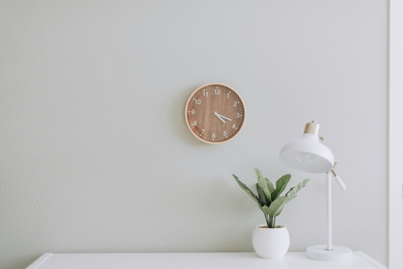 Plante, lampe et horloge sur une table