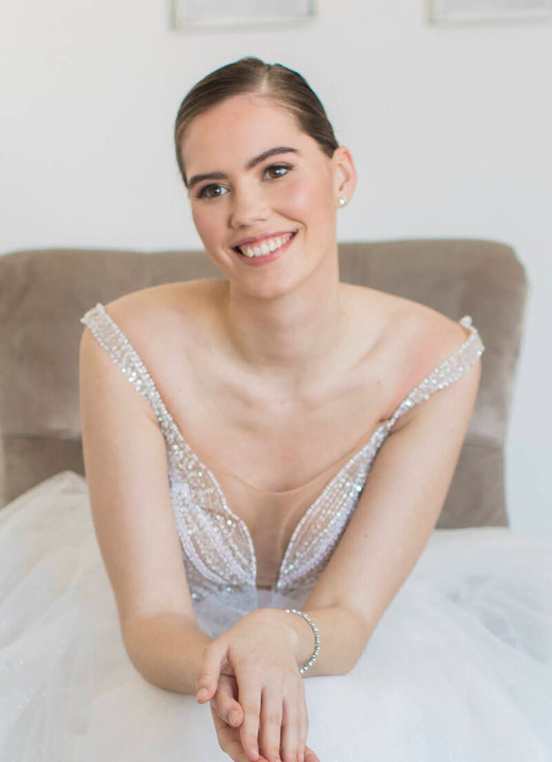 Bride sitting relaxed with beautiful hair and makeup