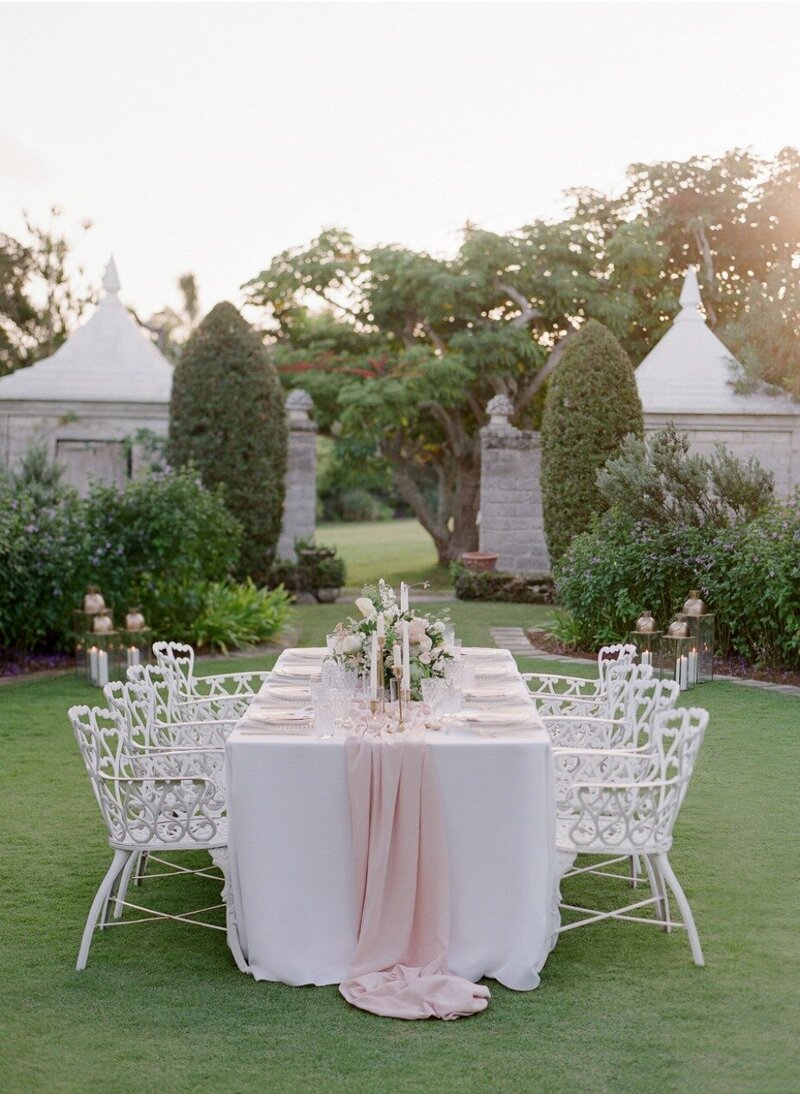 Elegant white table and chairs dinner setting