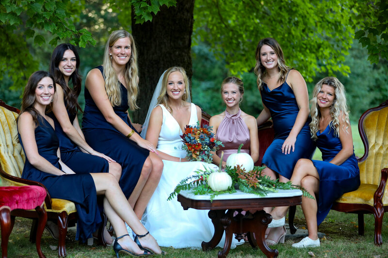 A bride sits with her bridal party after a wedding Ceremony : Light Shifter Studios 