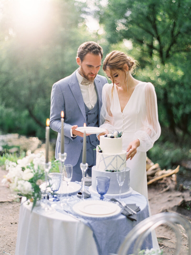 bride and groom with dusty blue table decor