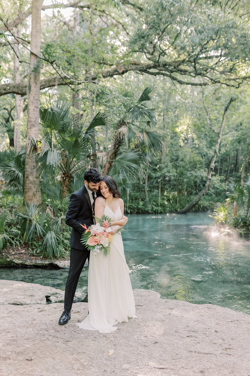 During their Iceland elopement, a bride and groom skipped through the lush green fields after their ceremony.