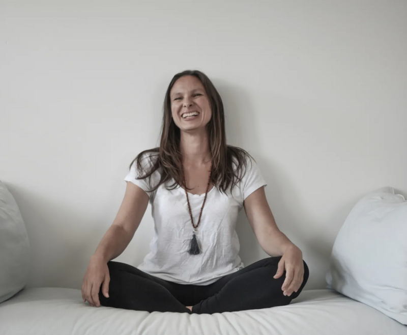 Woman laughing in yoga pose