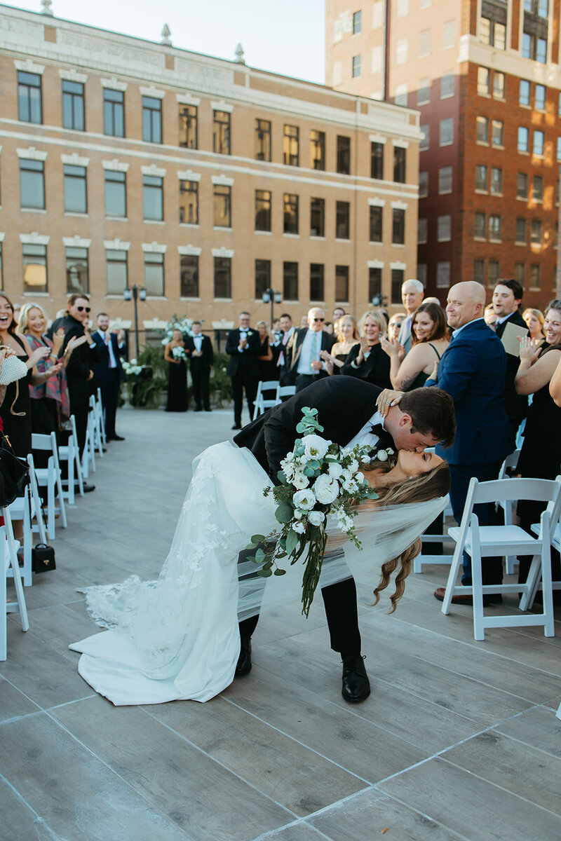 Bride and Groom share first kiss at Henry's Place at Niche in Wichita Kansas, Ashley Cole Photography