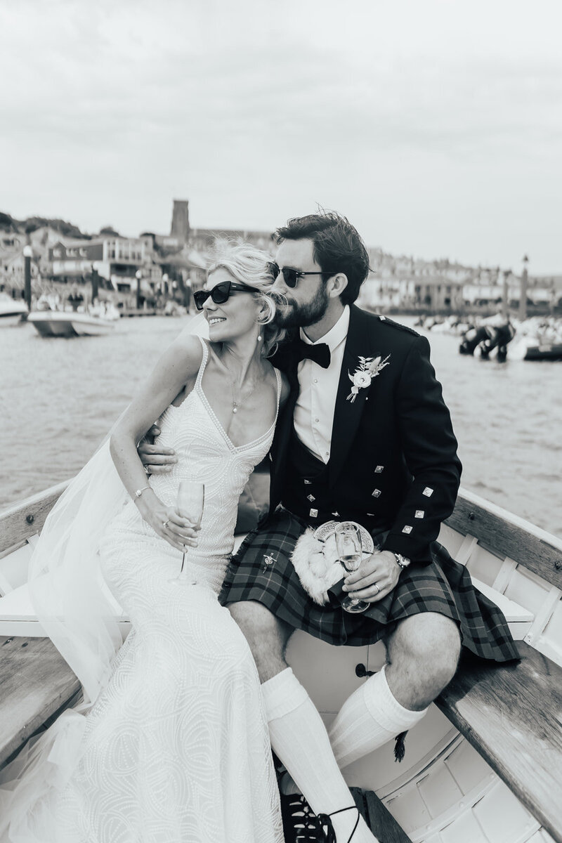 bride and groom wearing sunglasses on boat