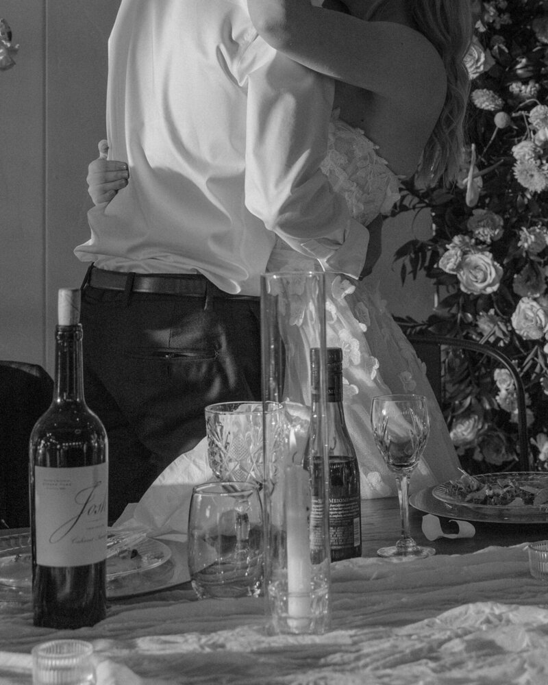 The couple celebrates with a kiss following touching speeches at their wedding reception in Dickinson at the August House Venue.