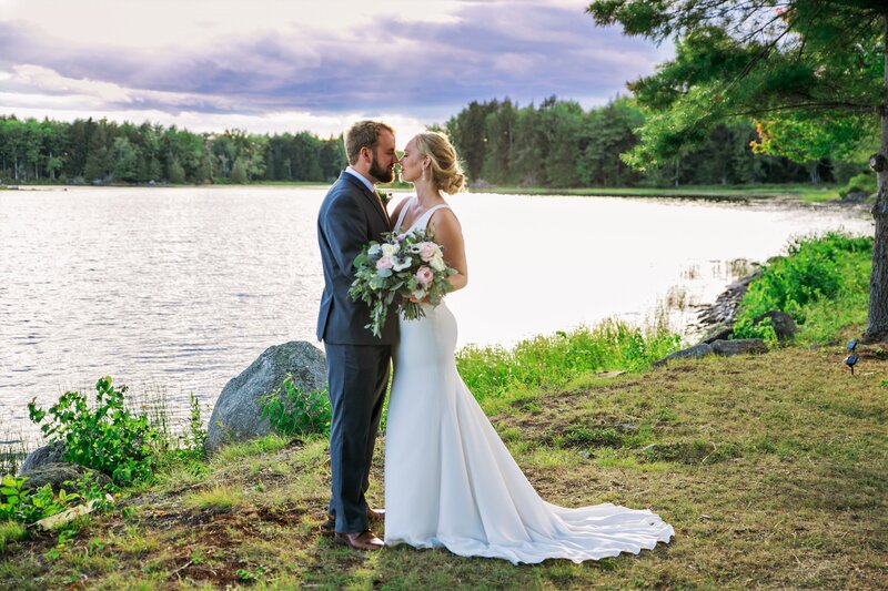 Bride and Groom kissing by the lake | Klein Wedding at Grace on the Lake taken by Wedding Photographer