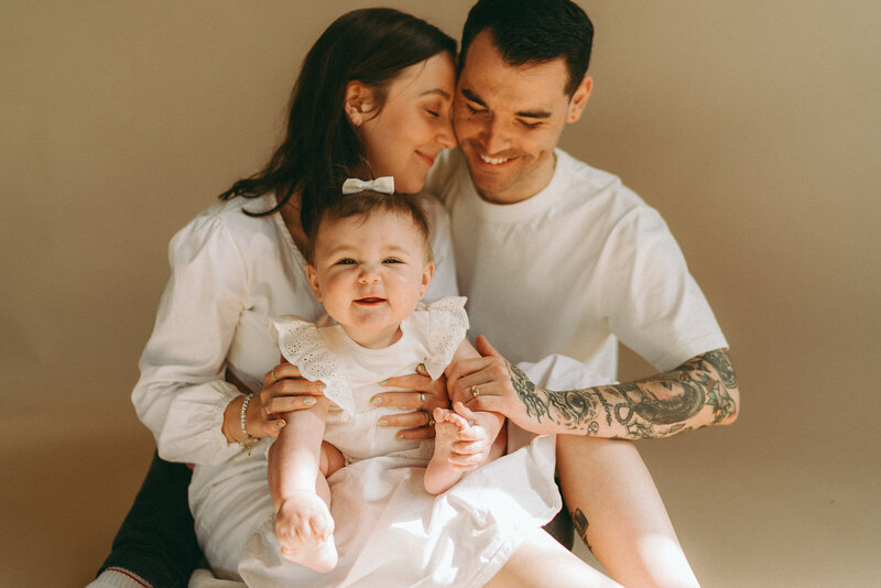 couple holding baby during studio newborn photoshoot captured by NYC newborn photographer Elsie Goodman 