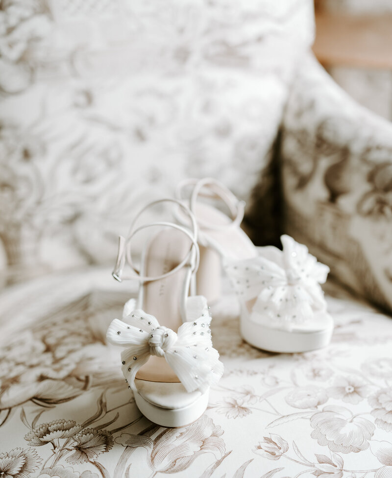 Bride's white heels on a vintage chair at The Four Seasons Hotel Boston, Massachusetts