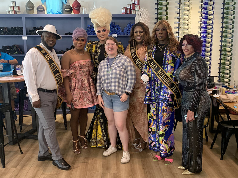 A Virginia intimate wedding photographer stands in front of a line of local drag queens and kings at a drag brunch at Wellhung Vineyard in Roanoke, Virginia.