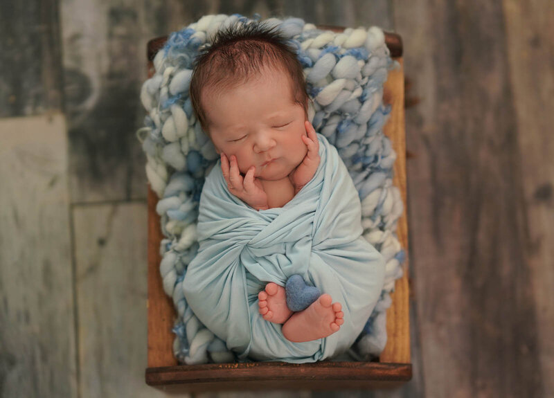 3-month old baby swaddled for a baby photoshoot