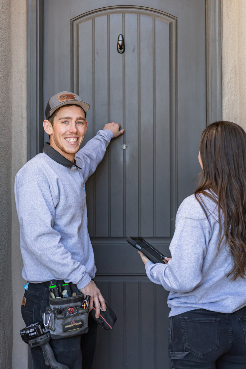 Two Electricians in Albuquerque knocking on front door of home