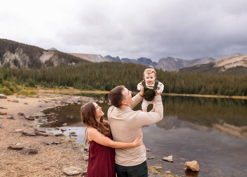family visiting colorado and enjoying photos in estes park colorado on a stormy summer evening