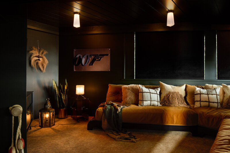 Interior brand photography of a home theater with comfortable seating and decor.