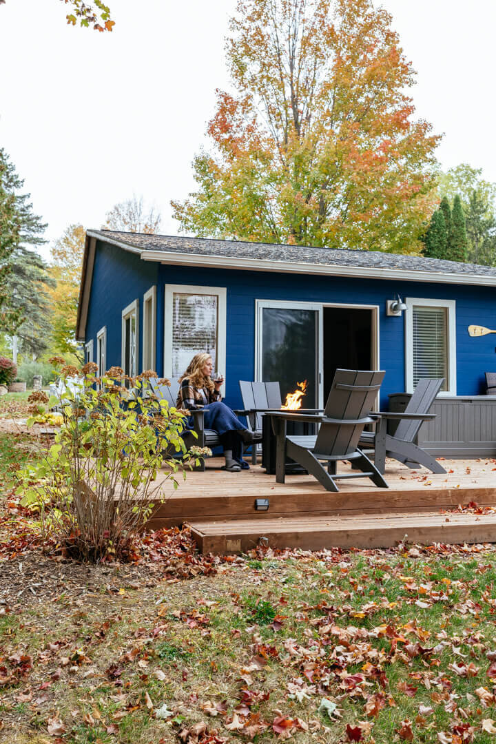 Blue lake house with outdoor furniture on deck