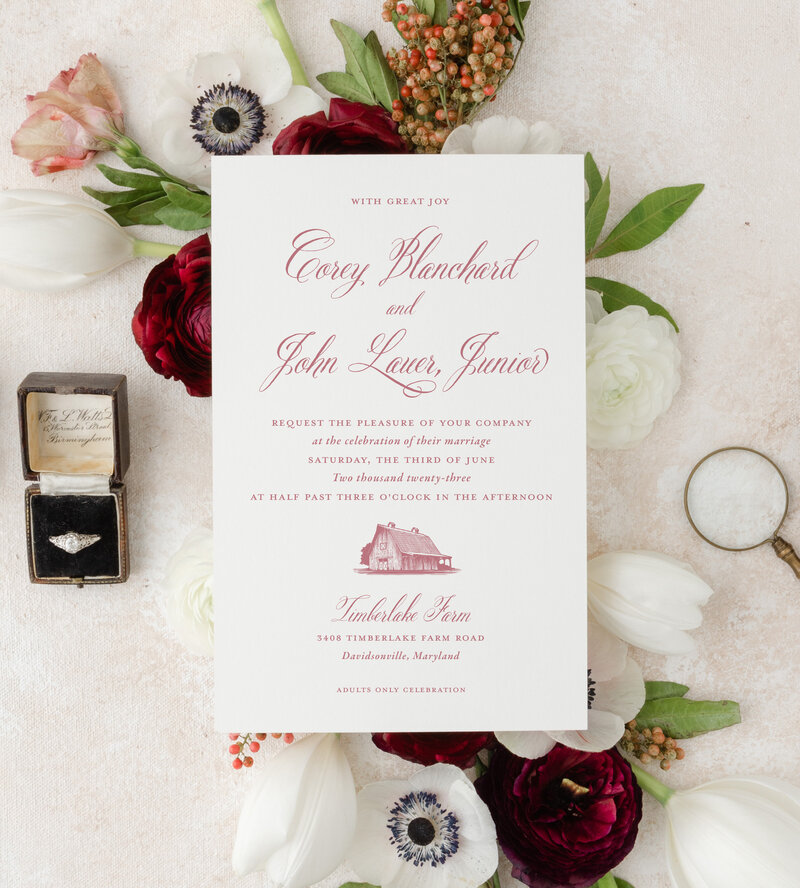 Custom floral wedding invitations with rink box and floral decor